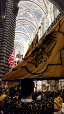 Aquila contrada flag bearer during mass inside the Duomo