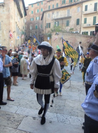 The march of the contrade into the church of Santa Maria in Provenzano, the patron of the July 2 Palio. The Palio banner is blessed here in a short ceremony.