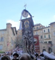 The Palio banner being carried into the church of Santa Maria in Provenzano. This is the prize for the winner of the Palio.