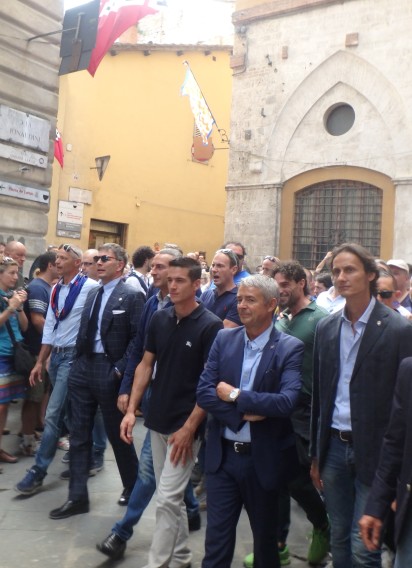 Giovanni Atzeni, center, walks into the Piazza with the Nicchio contrada. Atzeni, nicknamed "Tittia," has won five Palios, the most recent August 2015.