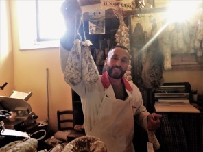 The salumeria owner, who was from Norcia. He told us about the recovery efforts, or lack thereof, in the town. He's holding up coglioni del mulo. It's a type of salami that gets its name from its shape: mule's balls. (!)