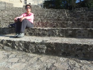 Sitting in the Roman ampitheater. Yes, that's me.
