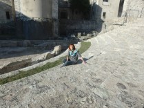 My friend Paola sitting in the Roman ampitheater