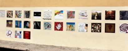 Brunello producers ask artists to design labels for their vintages. The samples are displayed on this wall in the town.